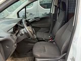 the interior of a car with the door open and the driver ' s seat down