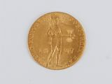 a close up of a gold coin on a white surface