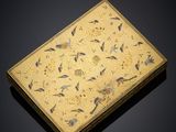an elaborately decorated box with birds and flowers on a black background