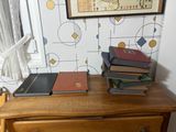 a dresser with a bunch of books on top of it