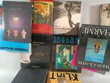 several books are stacked on top of each other on a table