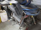 a pile of hoses and other items in a garage