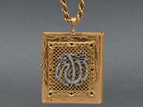 a close up of a gold necklace with a snake on it