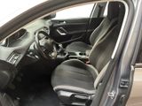 the interior of a car with the door open and the driver ' s seat down