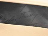 the bottom of a pair of beige shoes with writing on them
