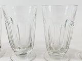 four glasses sitting next to each other on a table