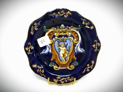 a blue and gold plate with a picture of a woman on it