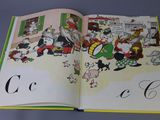an open book with a picture of a group of animals