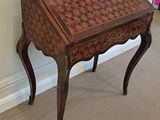 a small wooden desk with a checkered pattern on it