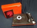 an orange box with a record on top of it next to a record player