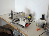 an image of a desk with a computer and sewing machine