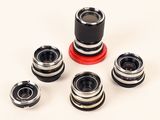 four different types of camera lenses on a white surface