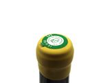 a close up of a bottle of wine on a white surface