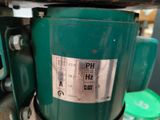 a close up of a green machine with a label on it