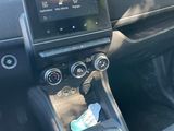 the interior of a car with a touch panel and steering controls