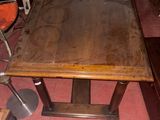 a wooden table and chairs in a room with a red floor