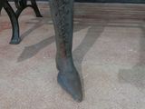 a statue of a woman ' s legs in a pair of boots