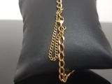 a close up of a black bag with a gold chain on it