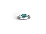 a close up of a ring with a green stone on it