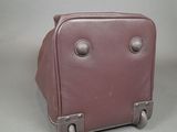 a purple suitcase sitting on top of a table