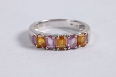 a close up of a ring on a table with a white background
