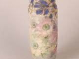 a vase with a floral design on it sitting on a table