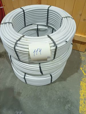 a close up of a coil of white plastic pipes in a warehouse