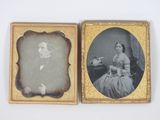 an old photo of a man and a woman sitting in front of a table