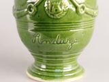 a green vase with a skull and crossbones on it