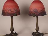 pair of red and gold glass lamps sitting on top of a table