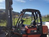 a forklift truck that is parked in the parking lot