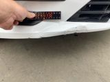 a hand that is holding a sticker on the front of a car