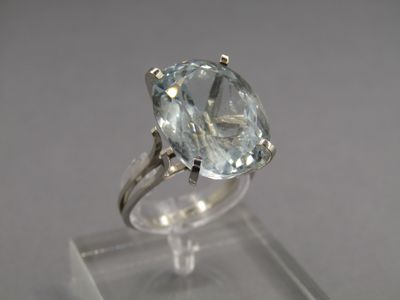 a close up of a ring with a large blue topaz stone