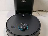 an image of a robotic vacuum cleaner sitting on top of a table