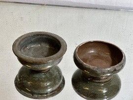 two vases that are sitting on a table