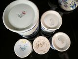 five cups and a bowl sitting on a table