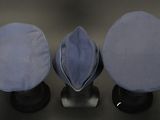 three hats are lined up in a row on a black surface