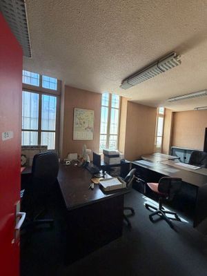an image of an empty office with a desk and chairs