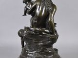 an image of a bronze statue of a woman holding a child