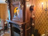 a fireplace in the middle of a room with a mirror on the wall