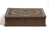 an old wooden box with ornate carvings on the lid