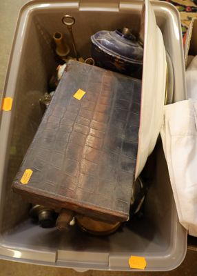a plastic container with a suitcase and other items inside of it