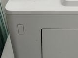a white printer sitting on top of a white box