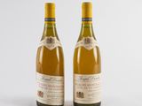 two bottles of wine sitting next to each other on a white surface