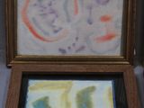 two paintings in a wooden box on a table