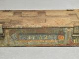 an old metal tool box sitting on top of a white surface