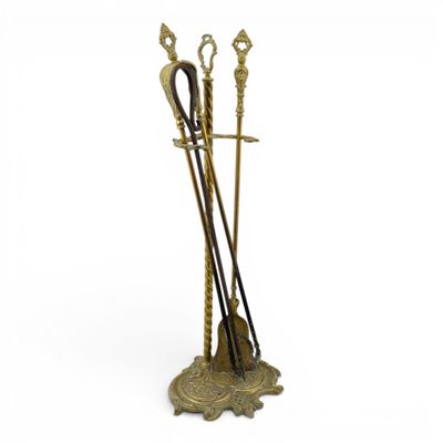 a pair of brass arrows on a stand with a white background