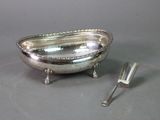 a silver plate with a spoon and fork on the table
