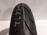 a close up of a motorcycle tire on a white surface