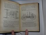 someone is holding an open book with a drawing of a train on it